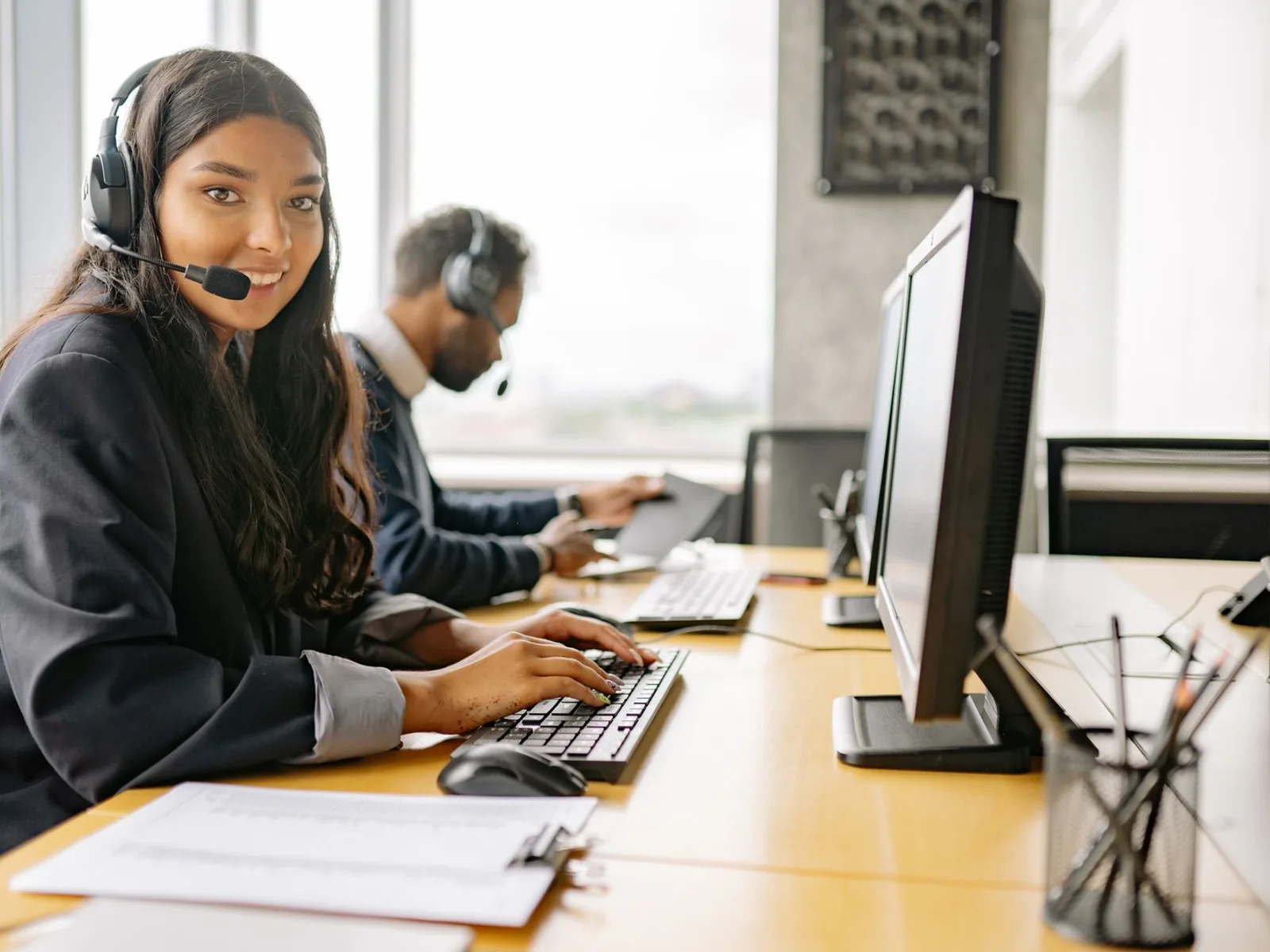 Helpful travel advisor on a headset, ready to assist with overseas flight fare quotes
