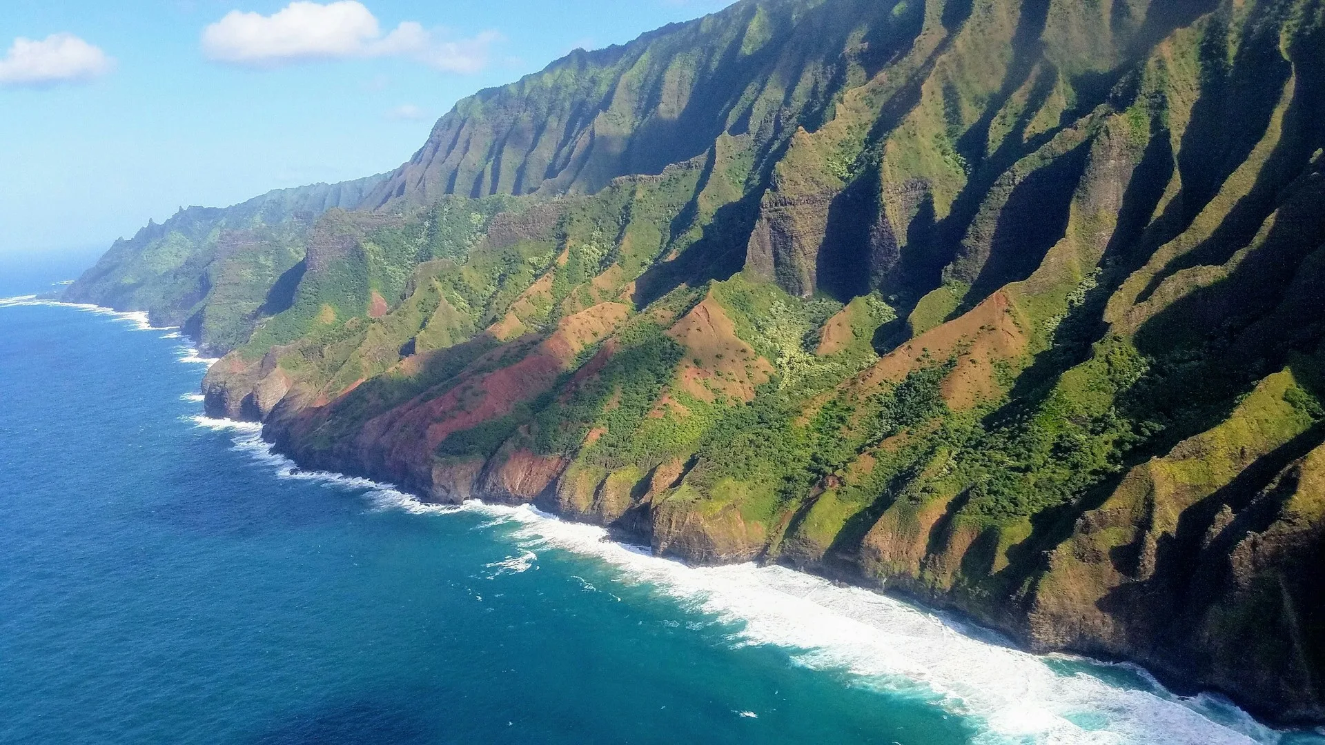 Green coastal cliffs overlooking the blue Pacific Ocean